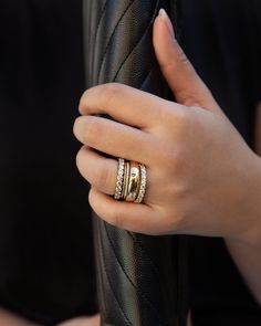 a woman's hand with two rings on it