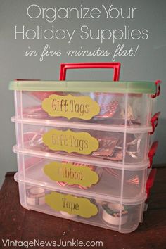 organized holiday supplies in plastic bins with labels on the top and bottom for free printable tags