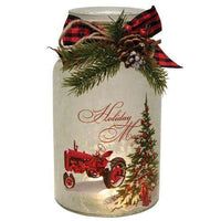 an old fashioned christmas jar with a red tractor and pine cones on it's lid