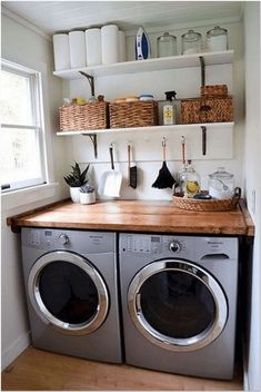 a washer and dryer in a small room with open shelving on the wall