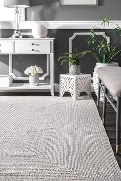 a living room with gray walls and white furniture