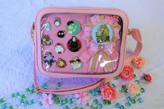 a pink purse filled with lots of assorted items on top of a white table