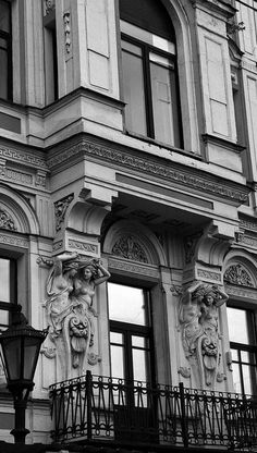 an old building with ornate windows and balconies on the outside, in black and white