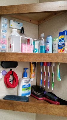 a bathroom shelf filled with lots of hygiene products