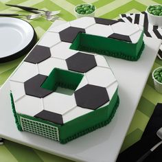 there is a cake that looks like the number five on it's side, with black and white designs