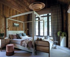 a bedroom with wood paneling and white bed in the center, along with two nightstands on either side