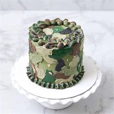 a camouflage cake is on a white plate