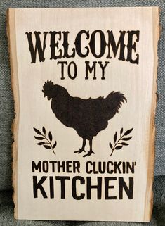 a sign that says welcome to my mother's kitchen with a chicken on it