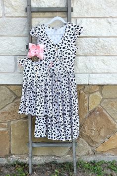 For a fun and stylish summer look, choose the Mama & Me Dalmation Print dress. This mother and daughter matching dress features a unique dalmation print that's sure to turn heads. Perfect for your next vacation or family event, this dress is sure to be a hit. Dalmation Print, Family Event, Mother And Daughter, Summer Look, Matching Dresses, Summer Looks, Print Dress, Turn Ons