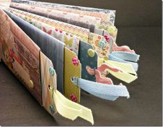 an open book with many different designs on it's cover and some ribbons hanging off the pages