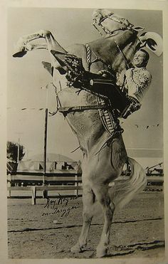 an old black and white photo of a man on a horse