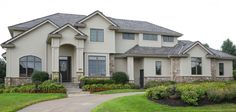 a large house with lots of windows and landscaping