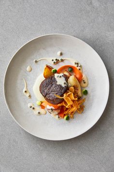 a white plate topped with food on top of a table