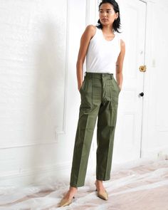 "Vintage army green utility slacks. High waist. Straight leg. Two side pockets. Two back pockets. Zipper fly. Fabric: 50% Cotton, 50% Polyester See dropdown menu for available sizes. Inseam varies between 29\" to 31\". Waist: 25.5\" Hips: 38\" Rise: 12\" Waist: 27\" Hips: 38\" Rise: 12\" Waist: 28\" Hips: 38\" Rise: 12\" Excellent vintage condition. Please note that each pair has unique distressing and subtle signs of wear that sometimes include small stains or minor mended areas. Photo represen Army Trousers, Army Fatigue, Office Pants, Pants Vintage, Trousers Women, Army Green, Business Casual, Capri Pants, Straight Leg