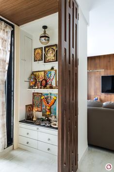 a living room filled with furniture and pictures on the wall