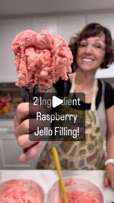 a woman holding up two scoops of ice cream in front of her face and the caption reads, 2 ingredient raspberry jello filling