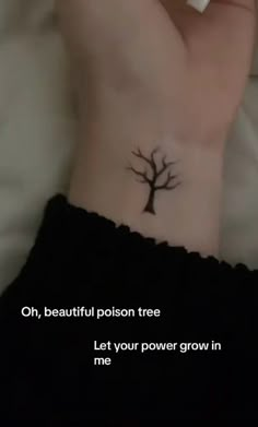 a person with a small tree tattoo on their left side of her arm and the words, oh, beautiful prison tree let your power grow in me