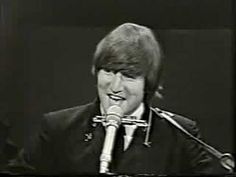 the beatles singer is singing into a microphone