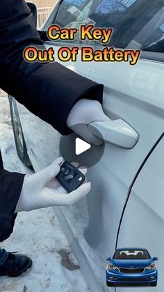 a car key is hooked up to an out of battery device in front of a white car