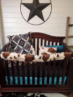 a baby crib with pillows and a star on the wall