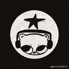 a bear with headphones and a star on it's forehead in front of a black background