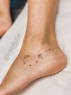 a woman's foot with the zodiac sign virgo on her left side and stars in the middle