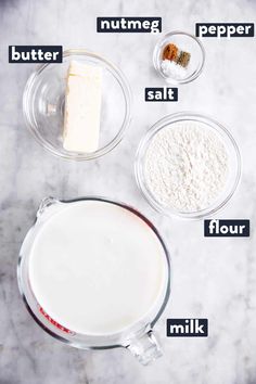 ingredients needed to make cheesecakes on a marble counter top, including butter, sugar and flour