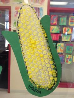 the corn on the cob is made out of plastic bottle caps and paper plates