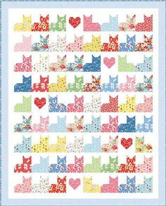 a colorful quilt with hearts and cats on it