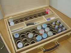 an open wooden box filled with lots of paint