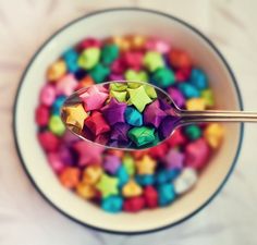 a bowl filled with lots of different colored stars