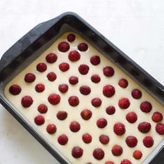 a pan filled with batter and fresh strawberries