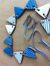 several pieces of art made out of wood and metal with scissors in the shape of triangles