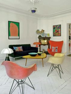 an image of a living room setting with modern furniture and art on the wall behind it