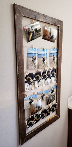 a wooden frame with pictures hanging on it