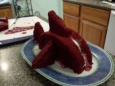 a cake that has been cut into pieces and is sitting on a plate in the kitchen