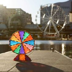 a colorful ferris wheel sitting on top of a pier