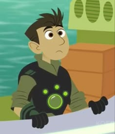 a boy in a black and green outfit on a boat looking at the water from behind him