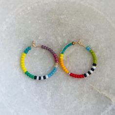 "Brightly colored beaded hoop earrings, lightweight & perfect for everyday wear! Each pair is handmade to be unique so these also make great gifts! Made with gold filled hoops, approximately 3/4\" or 20mm in diameter.  **Note: 2nd photo is purely to show scale & is not earring included in this pair." Nickel-free Heishi Bead Hoop Earrings, Hoop Beaded Earrings With Spacer Beads, Colorful Beads Small Hoop Jewelry, Nickel-free Hoop Earrings With Heishi Beads, Adjustable Hoop Earrings With Colorful Beads, Nickel Free Hoop Beaded Earrings For Everyday, Colorful Round Bead Earrings For Everyday, Trendy Hoop Earrings With Tiny Beads, Beaded 14k Gold Filled Hoop Earrings