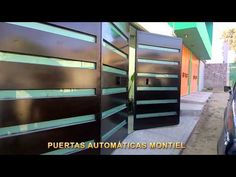 a car parked on the side of a road next to a building with metal doors