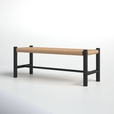 a wooden bench sitting on top of a white floor next to a black metal frame