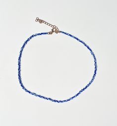 Beaded Necklace in dark blue with light blue flecks.  Very trendy jewelry piece right now. Looks amazing layered with gold chains or other beaded pieces and a bikini, dress or tank top! Adjustable length short necklace. Longest length= 44cm Shortest Length = 39cm (total chain length when open). Please make sure to measure your neck/wrist/ankle circumference when buying jewellery to insure a good fit. Thank you for supporting Small Women Owned Businesses! :) x TAGS - pinterest, groovy, beach, fas Blue Tiny Beads Choker For Summer, Blue Beaded Choker For Summer, Trendy Blue Beaded Chain Necklace, Trendy Blue Jewelry With Tiny Beads, Summer Blue Beaded Choker, Handmade Blue Choker For Summer, Blue Handmade Choker For Summer, Blue Beach Jewelry With Adjustable Chain, Summer Chain Choker Necklace