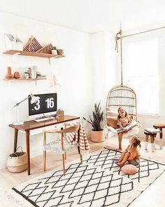 a woman sitting on a chair in a living room with a tv and shelves above her