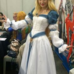 a woman dressed in a white and blue costume