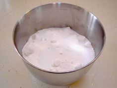 a metal bowl filled with white powder on top of a counter