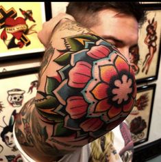 a man with tattoos covering his face and arm