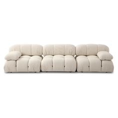 a white couch sitting on top of a white floor