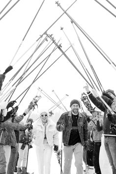 a group of people standing around each other on skis