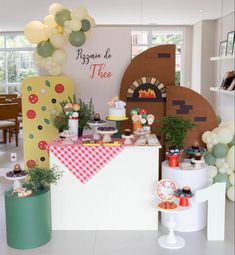 a table topped with lots of food and balloons