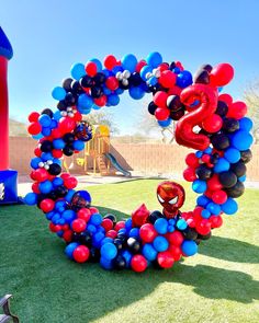 an image of balloons in the shape of a heart on artificial grass at a playground